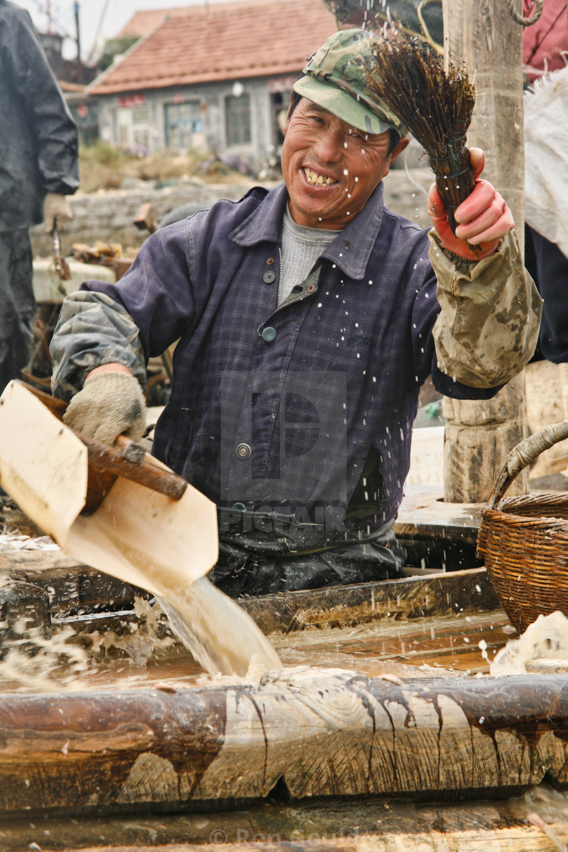 "Man cleaning fishing boat" stock image