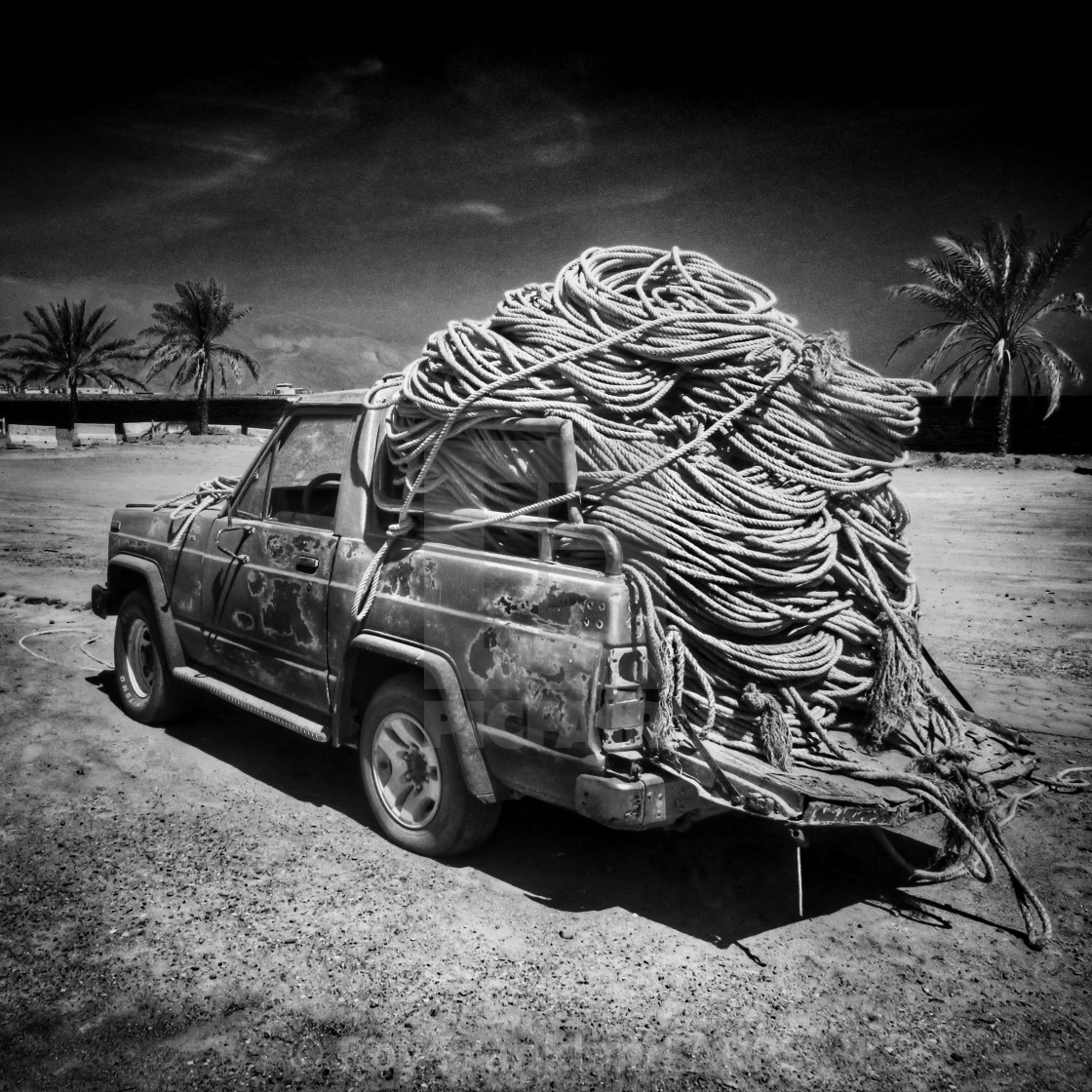 "Abandoned Nissan with old rope, mono" stock image