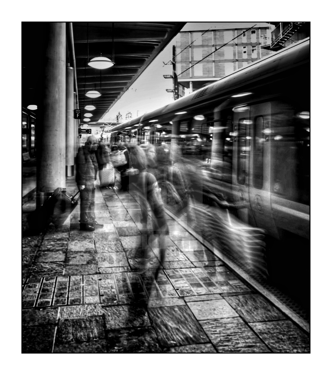 "Train station platform, with moving people, mono" stock image