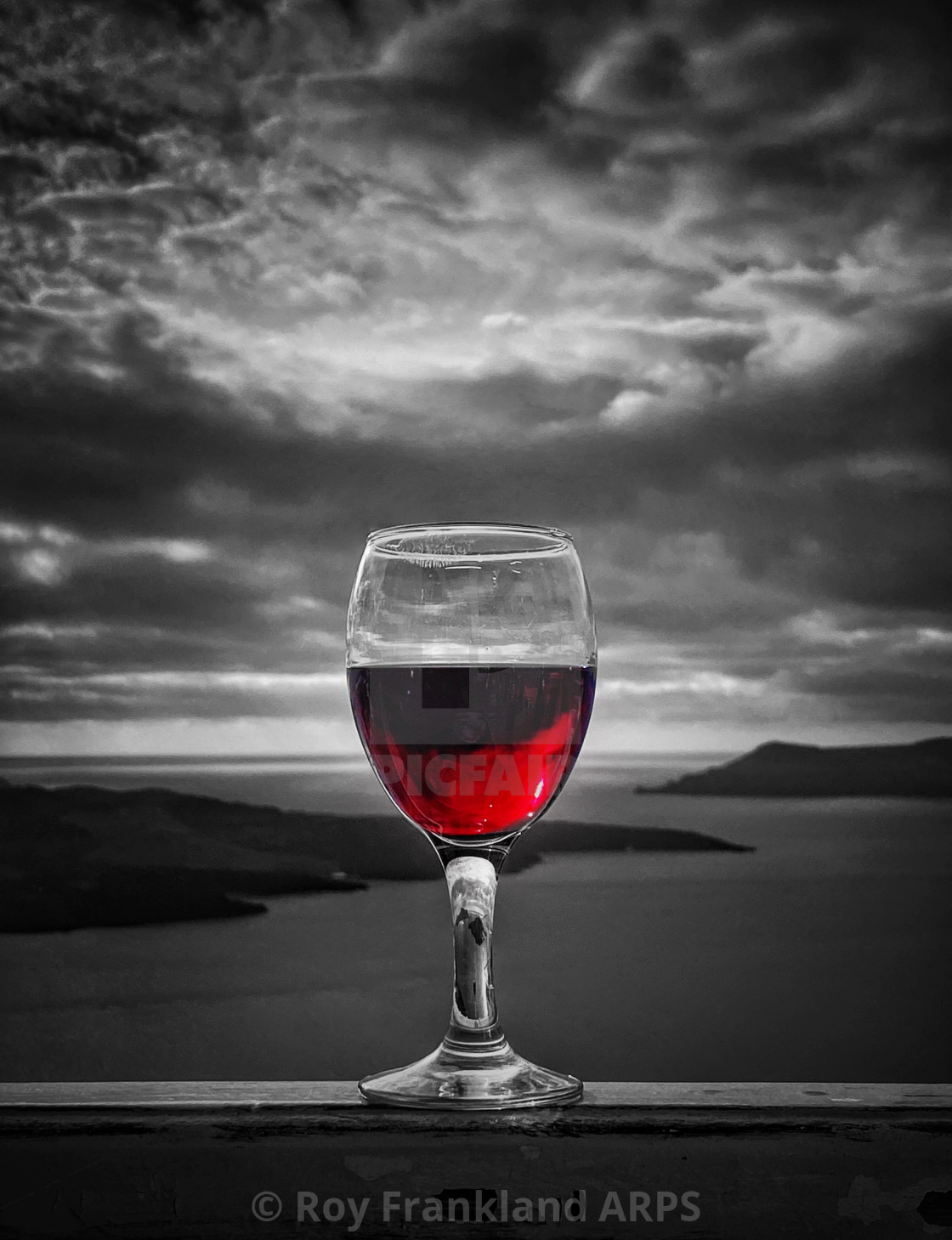 "Glass of red wine and a stormy sky" stock image