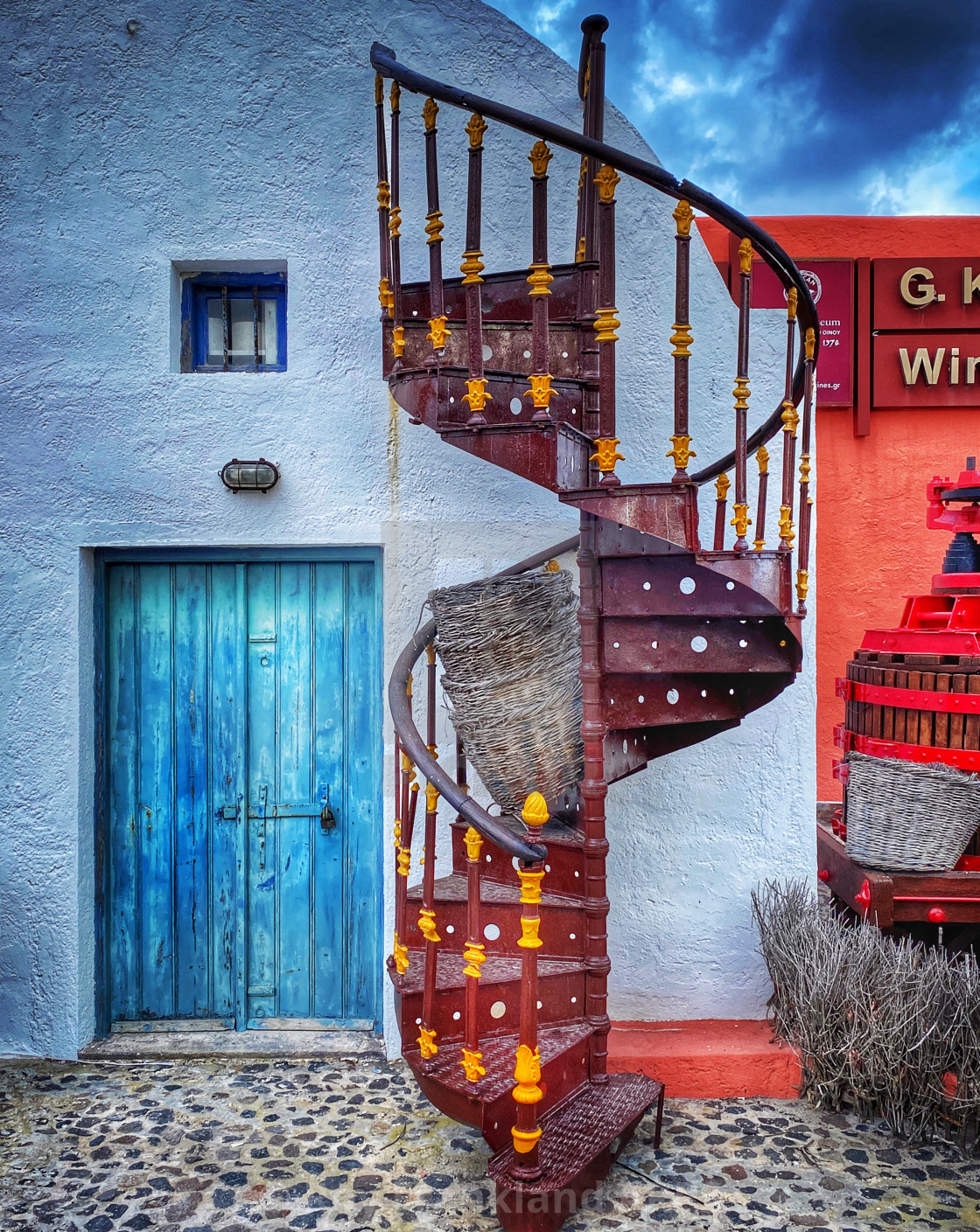 "Spiral staircase and blue door" stock image