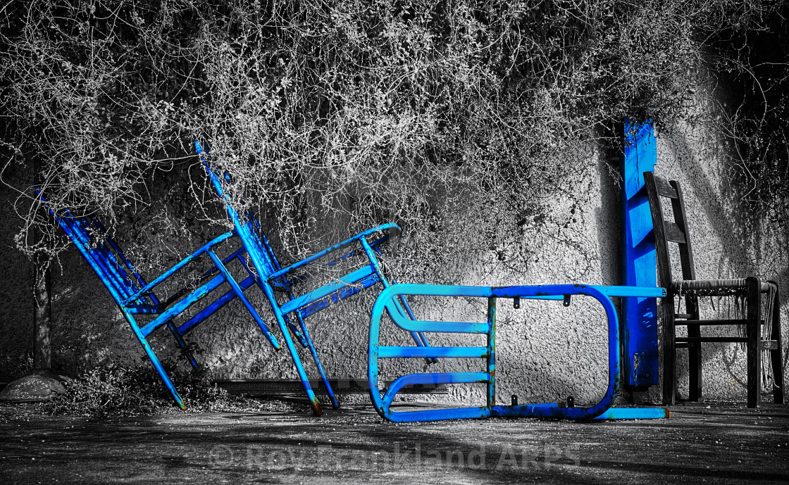 "Broken blue chairs, selectively coloured" stock image