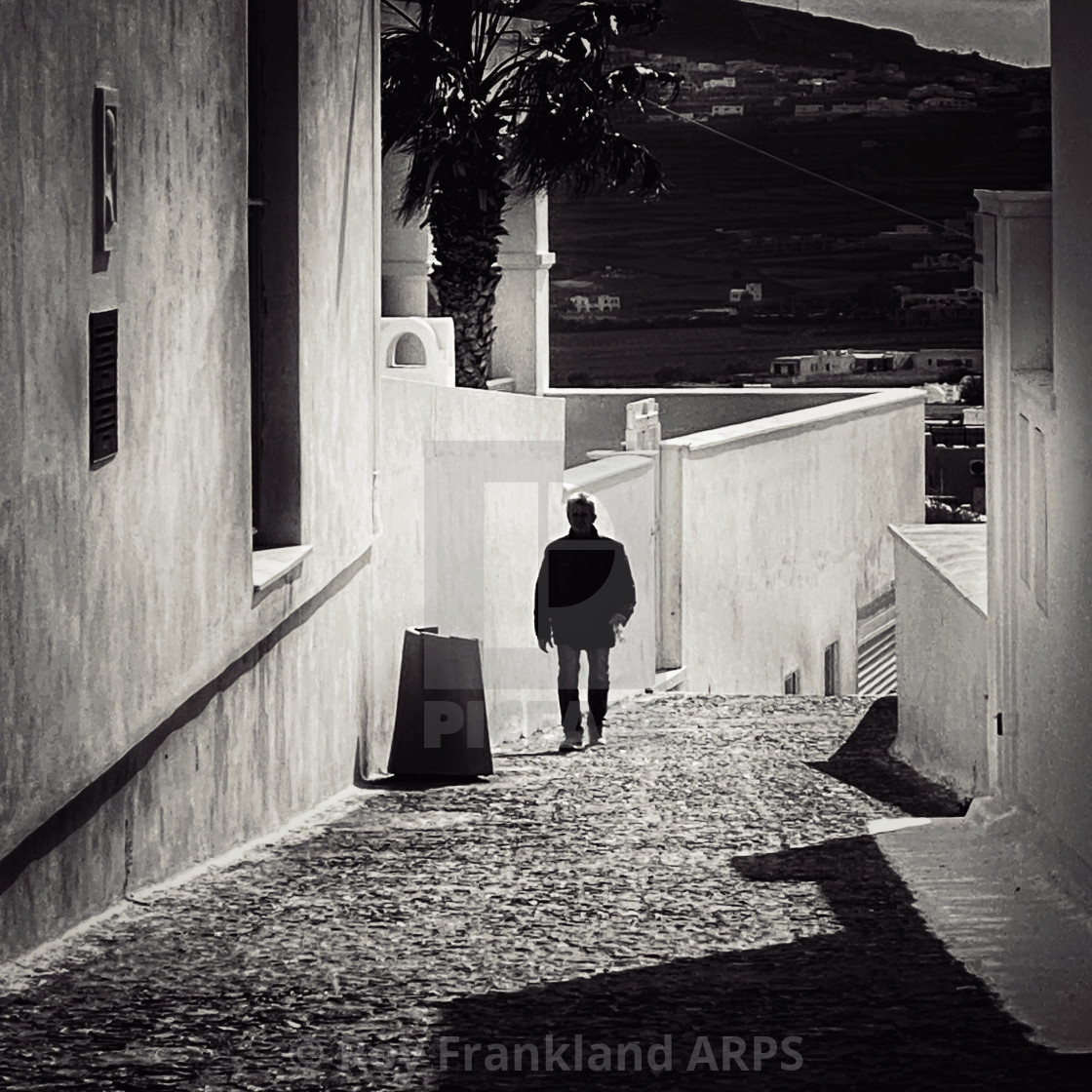 "Man on a cobblestone street" stock image