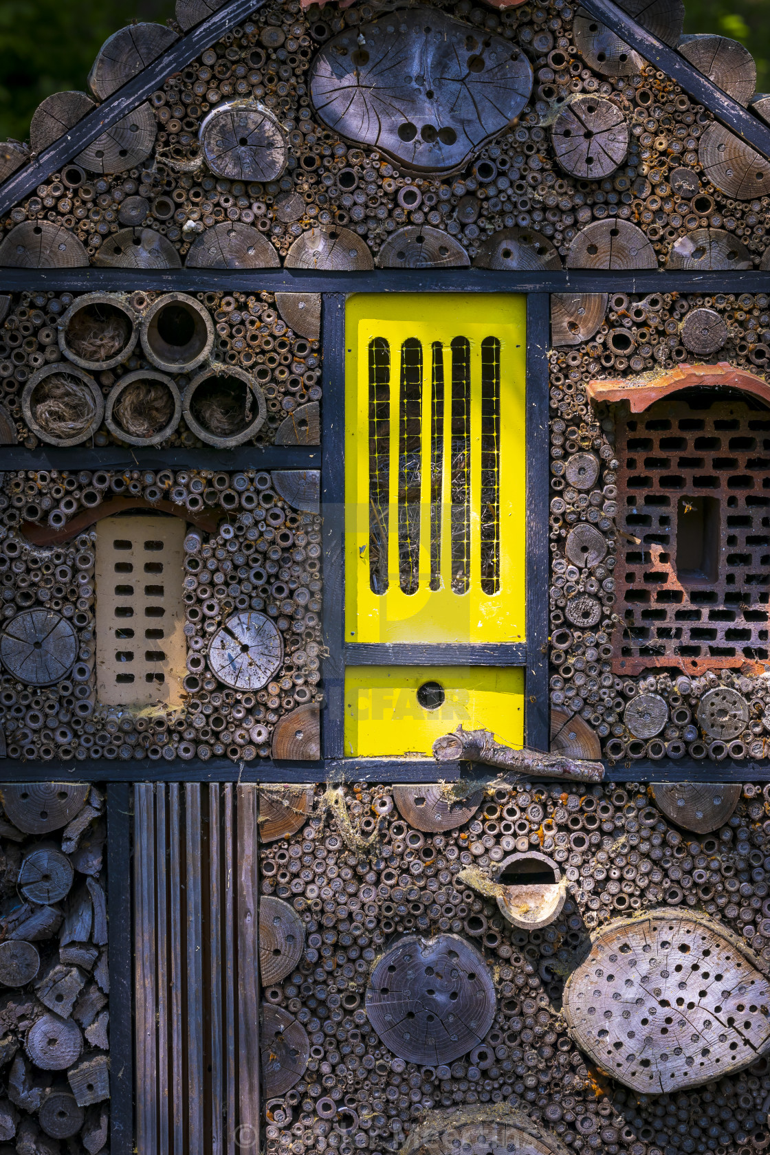 "Manmade insect hotel in a green forest and flowers" by Sander Meertins - $5.36 "Manmade insect hotel in a green forest and flowers" stock image