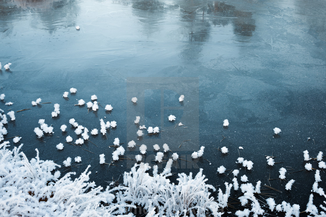 "Snow flakes on frozen lake" stock image