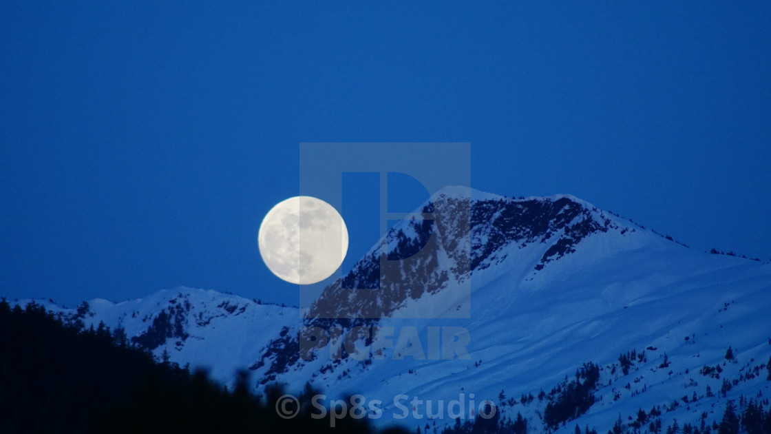 "Moon over the mountain" stock image