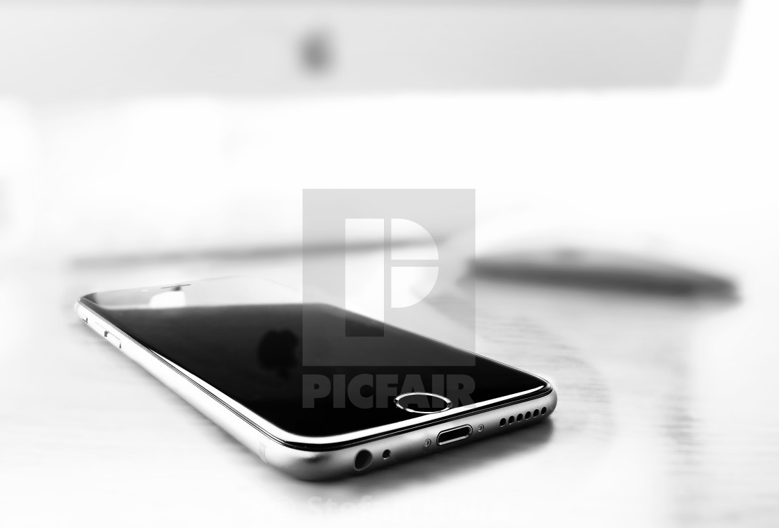 "The new iPhone 6 on a desk with iMac and mouse" by Stefan Holm - $6.32 "The new iPhone 6 on a desk with iMac and mouse" stock image