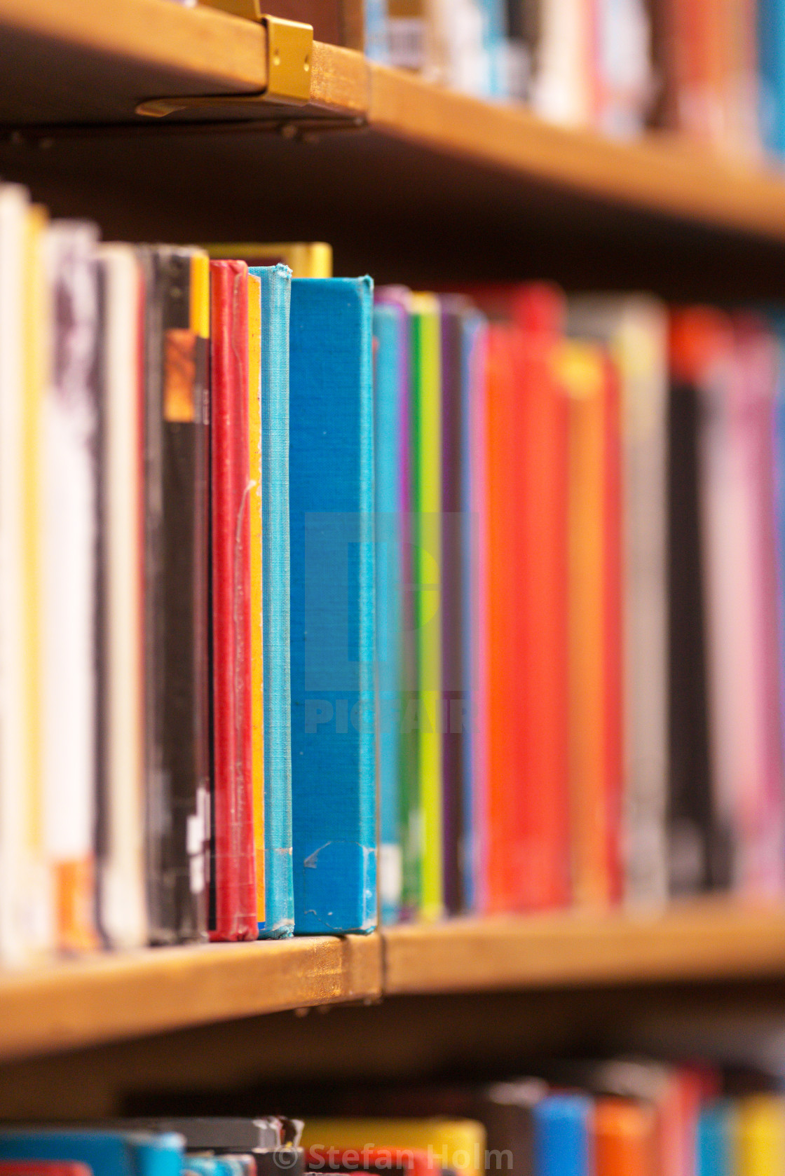 "Colorful books on the shelfs with shallow depth of field at the" stock image