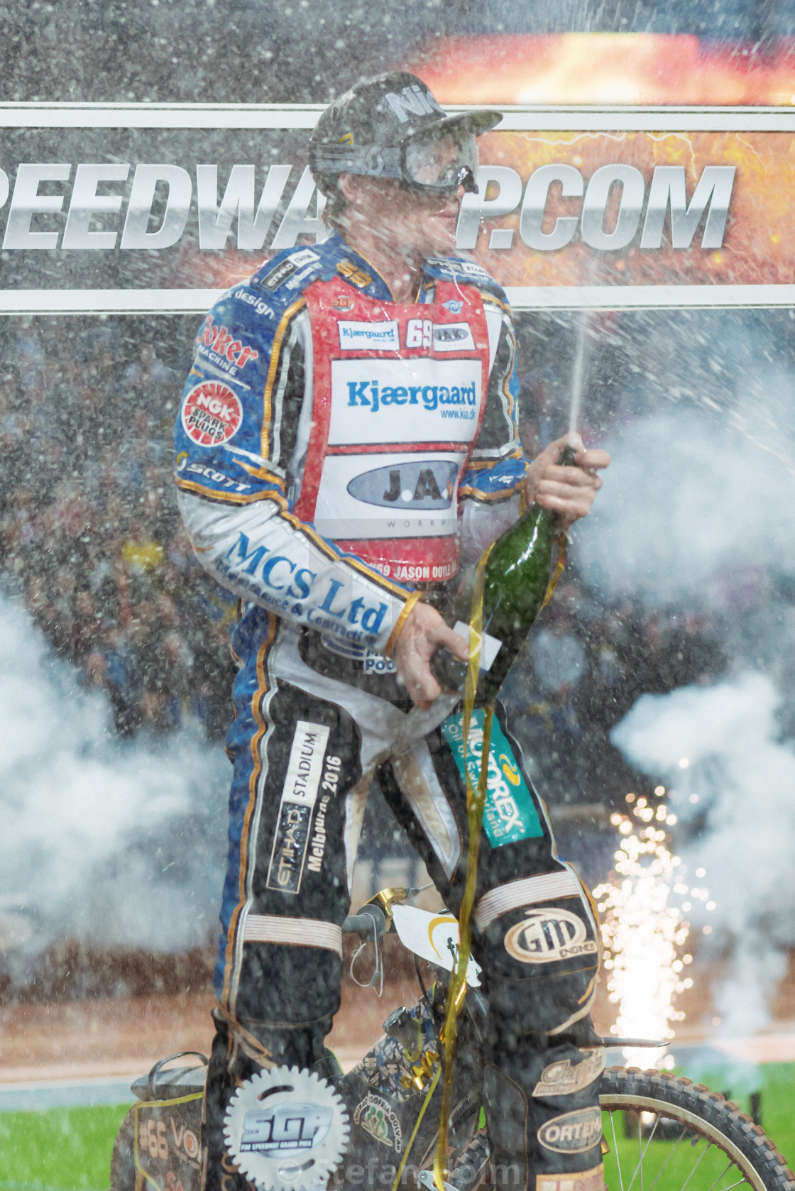"Winner Jason Doyle with Champagne and fireworks at Stockholm FIM" by Stefan Holm - $6.29 "Winner Jason Doyle with Champagne and fireworks at Stockholm FIM" stock image