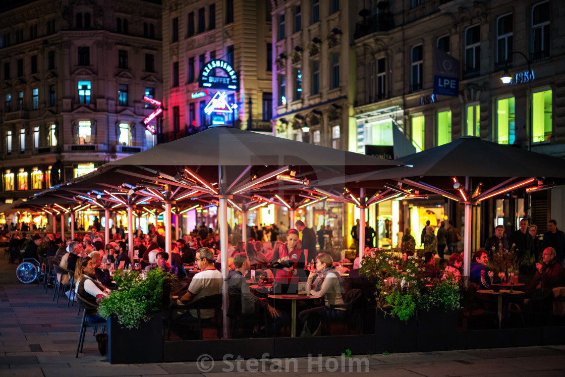 "VIENNA, AUSTRIA, OCTOBER 23, 2019: People sitting at the colorful terrace of a Vienna Bar Cafe, being heated with electric heaters." by Stefan Holm - $6.32 "VIENNA, AUSTRIA, OCTOBER 23, 2019: People sitting at the colorful terrace of a Vienna Bar Cafe, being heated with electric heaters." stock image