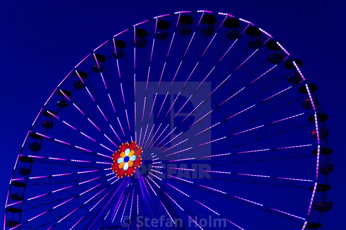"Colorful ferriswheel in vivid neon colors during evening with a" by Stefan Holm - $6.34 "Colorful ferriswheel in vivid neon colors during evening with a" stock image