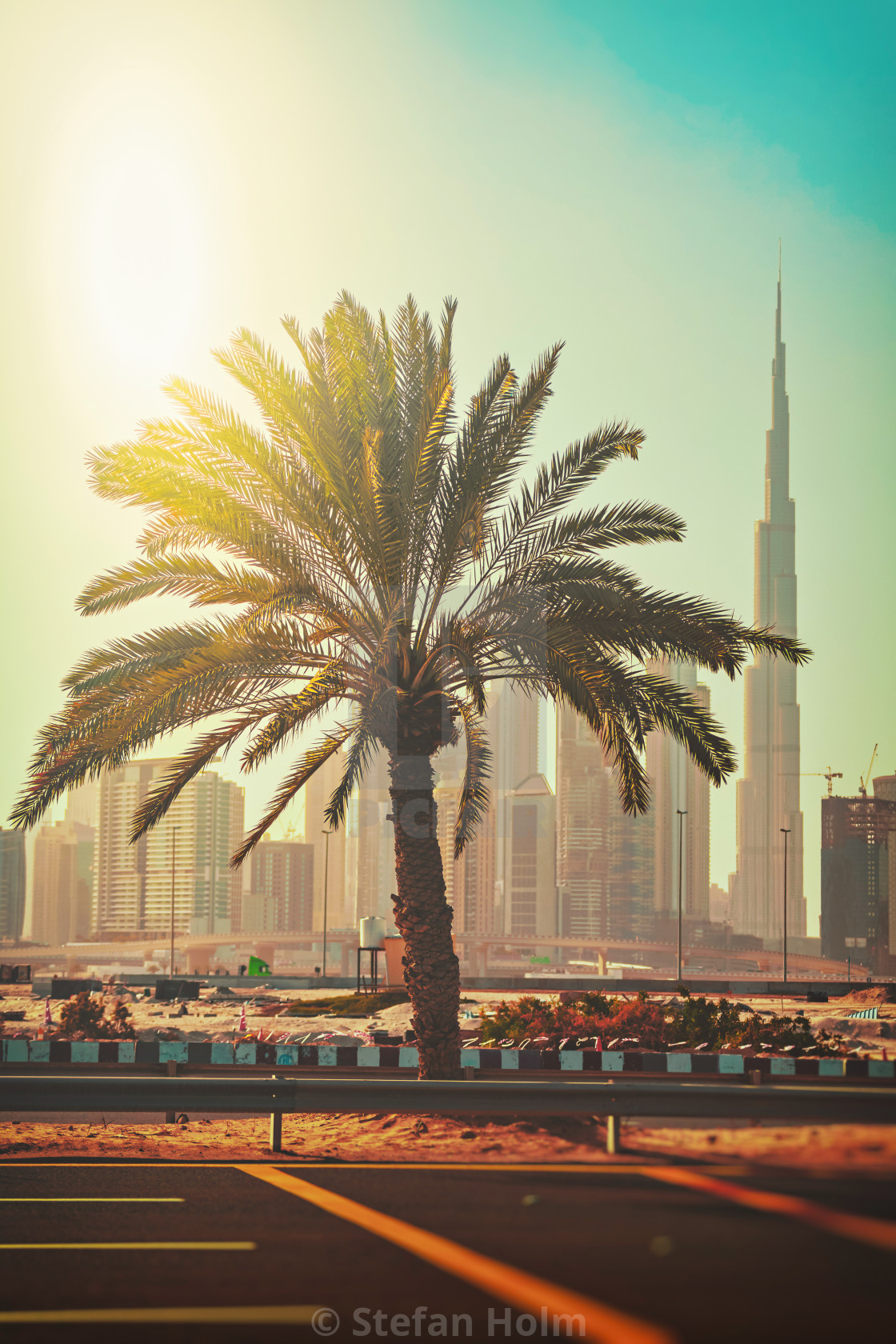 "Palm tree at a parking lot with Burj Khalifa and the city center" by Stefan Holm - $6.32 "Palm tree at a parking lot with Burj Khalifa and the city center" stock image
