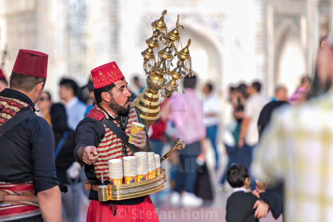 "Coffe salesman in a red fez with brass container on his back" by Stefan Holm - $6.31 "Coffe salesman in a red fez with brass container on his back" stock image