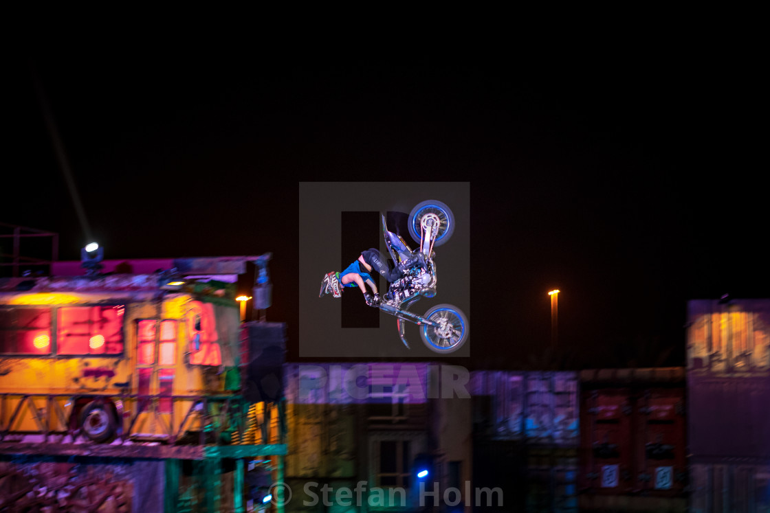 "Motorcycle in a colorful stunt show with industry decor at the G" by Stefan Holm - $6.32 "Motorcycle in a colorful stunt show with industry decor at the G" stock image