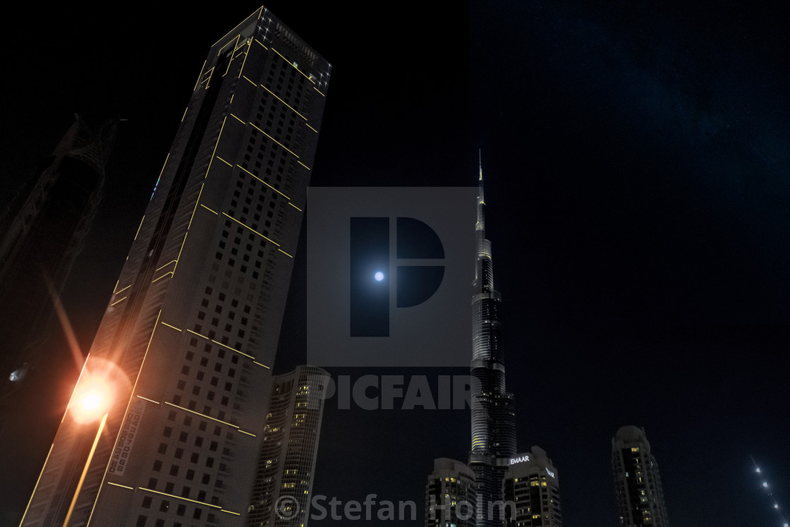"Full moon with Burj Khalifa surrounded with other tall buildings" by Stefan Holm - $6.35 "Full moon with Burj Khalifa surrounded with other tall buildings" stock image