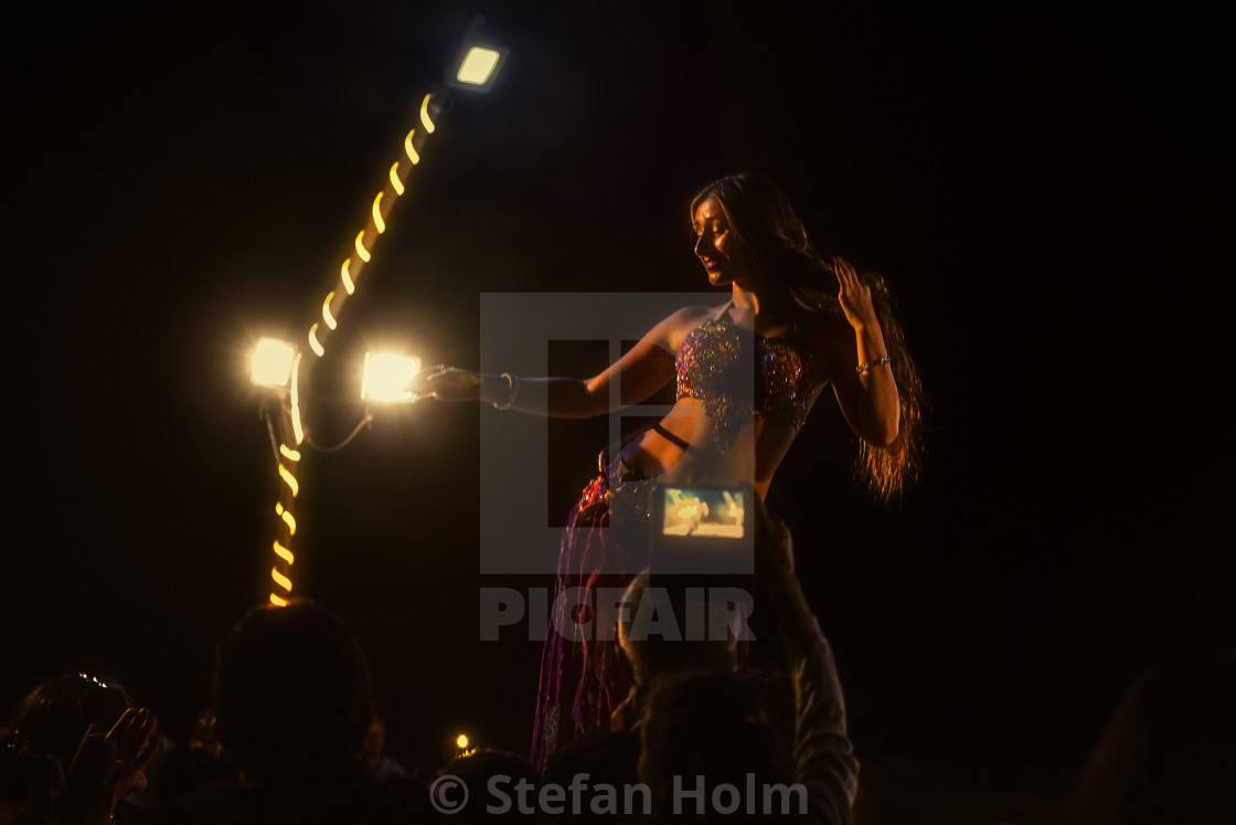 "Blonde long haired belly dancer at a desert trip with food and e" stock image