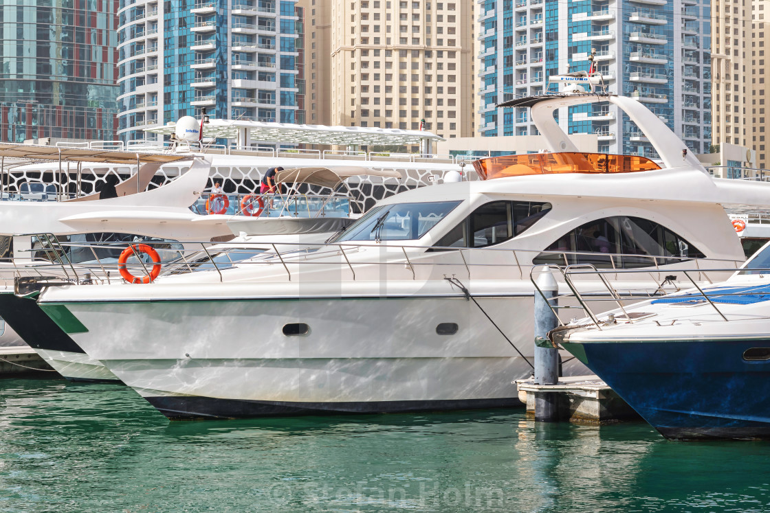 "Yachts packed tight togheter at the Dubai marina with highrise r" by Stefan Holm - $6.32 "Yachts packed tight togheter at the Dubai marina with highrise r" stock image