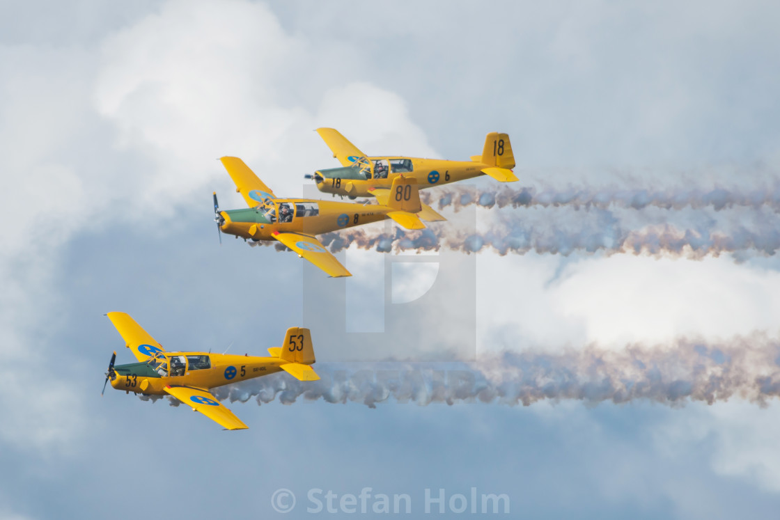 "Group of yellow SK 50 in formations in the airshow at Orebro air" by Stefan Holm - $6.30 "Group of yellow SK 50 in formations in the airshow at Orebro air" stock image