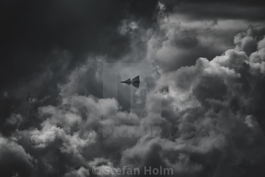 "Silhouette of JA37 of Viggen in black and white during cloudy we" by Stefan Holm - $6.34 "Silhouette of JA37 of Viggen in black and white during cloudy we" stock image