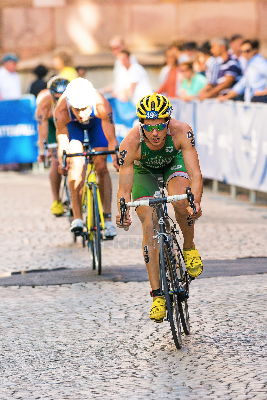 "Rodrigo Gonzalez (MEX) leads a group of triathletes on the cobblestone road" by Stefan Holm - $6.29 "Rodrigo Gonzalez (MEX) leads a group of triathletes on the cobblestone road" stock image
