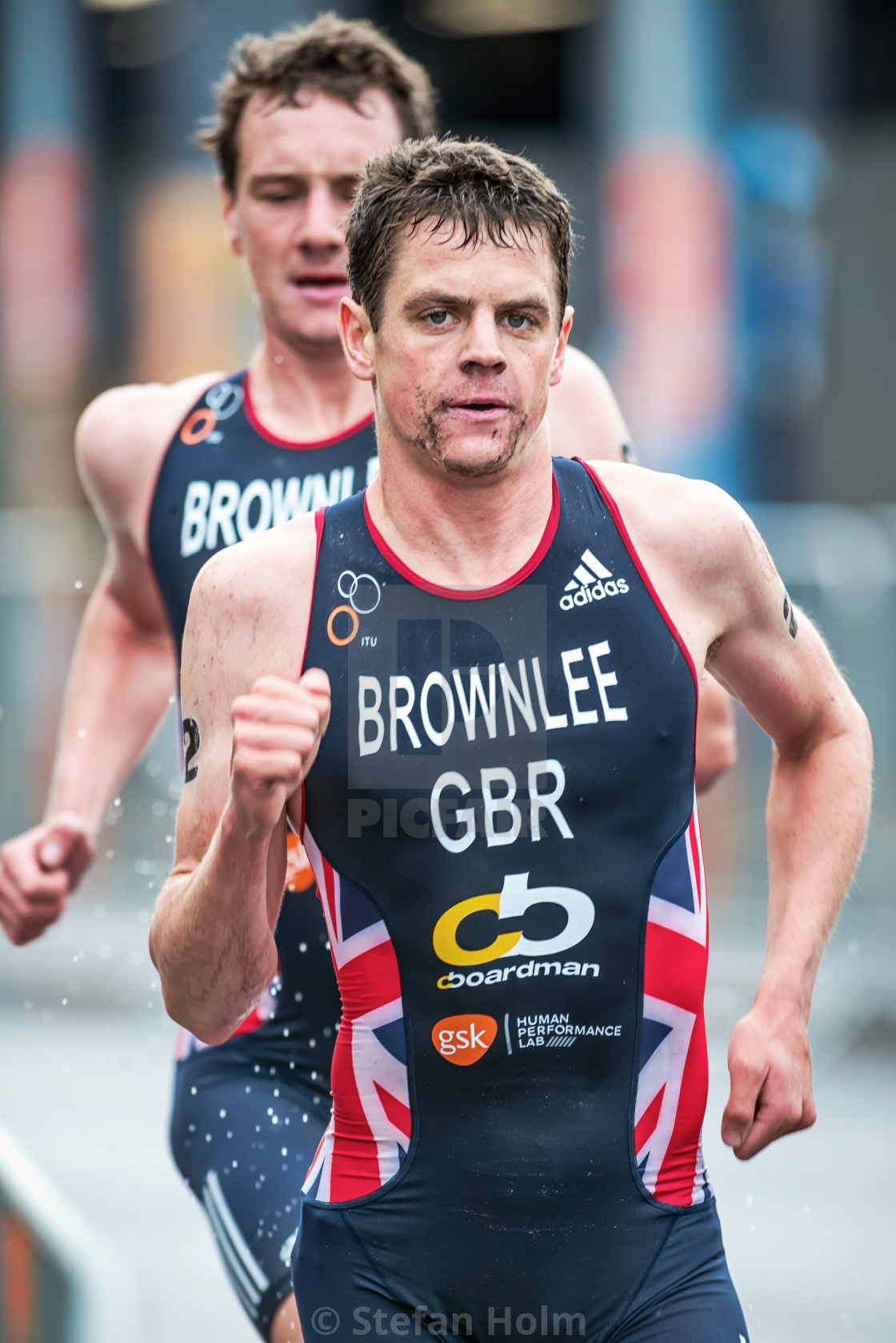 "Jonathan Brownlee running with a focused face with Alistair behi" by Stefan Holm - $6.32 "Jonathan Brownlee running with a focused face with Alistair behi" stock image