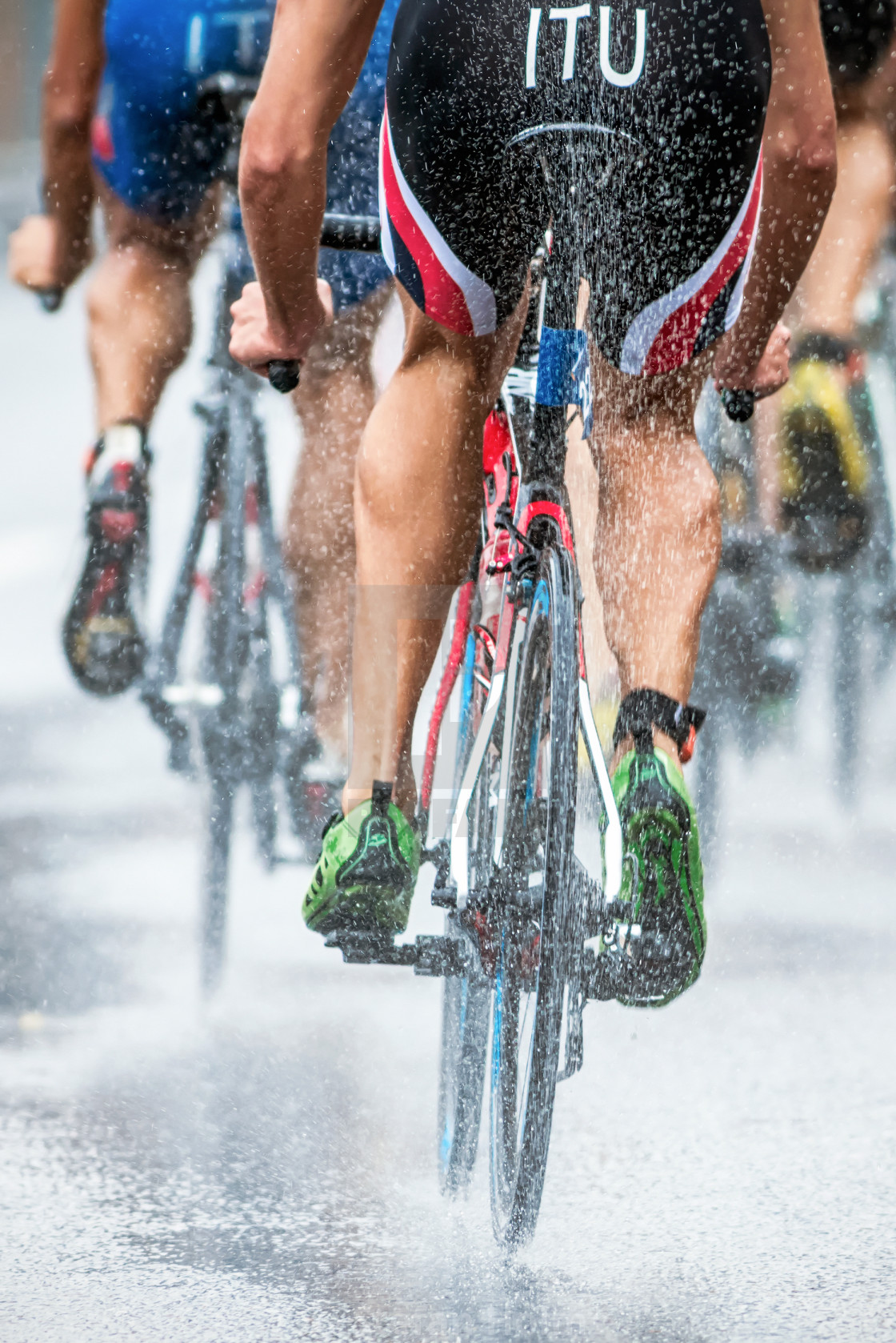 "Triathletes cycling in the heavy rain with water spraying from t" by Stefan Holm - $6.32 "Triathletes cycling in the heavy rain with water spraying from t" stock image