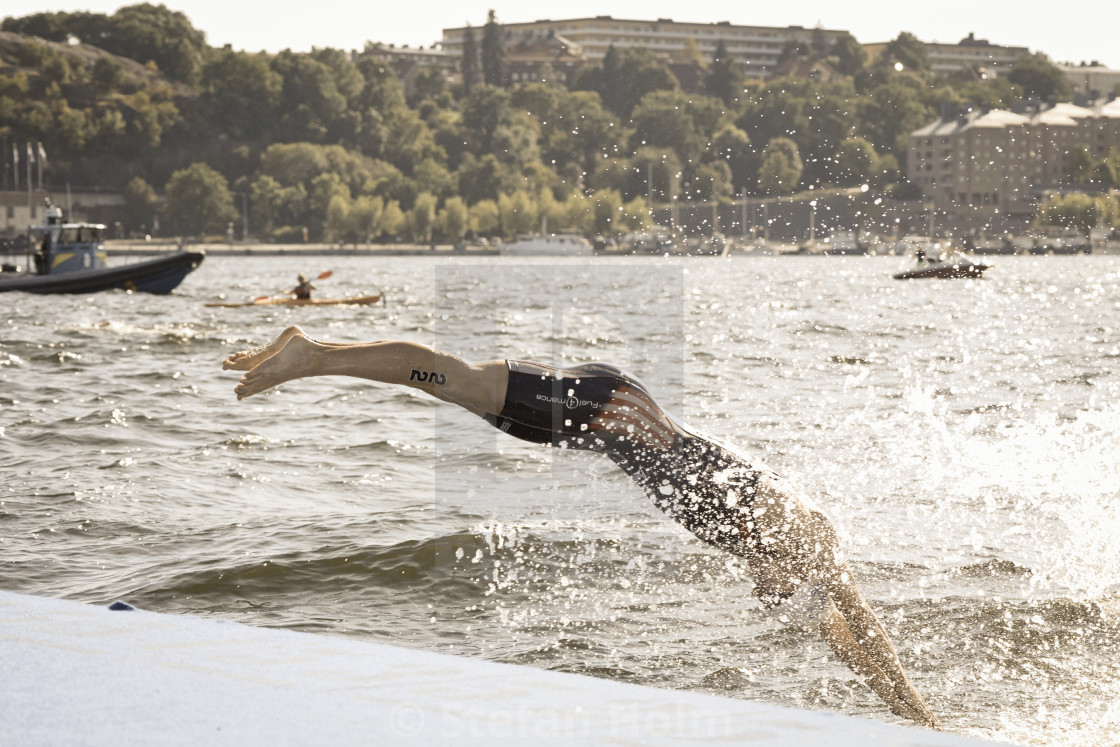 "Ben Kanute from the USA at the first lap diving into the water a" stock image