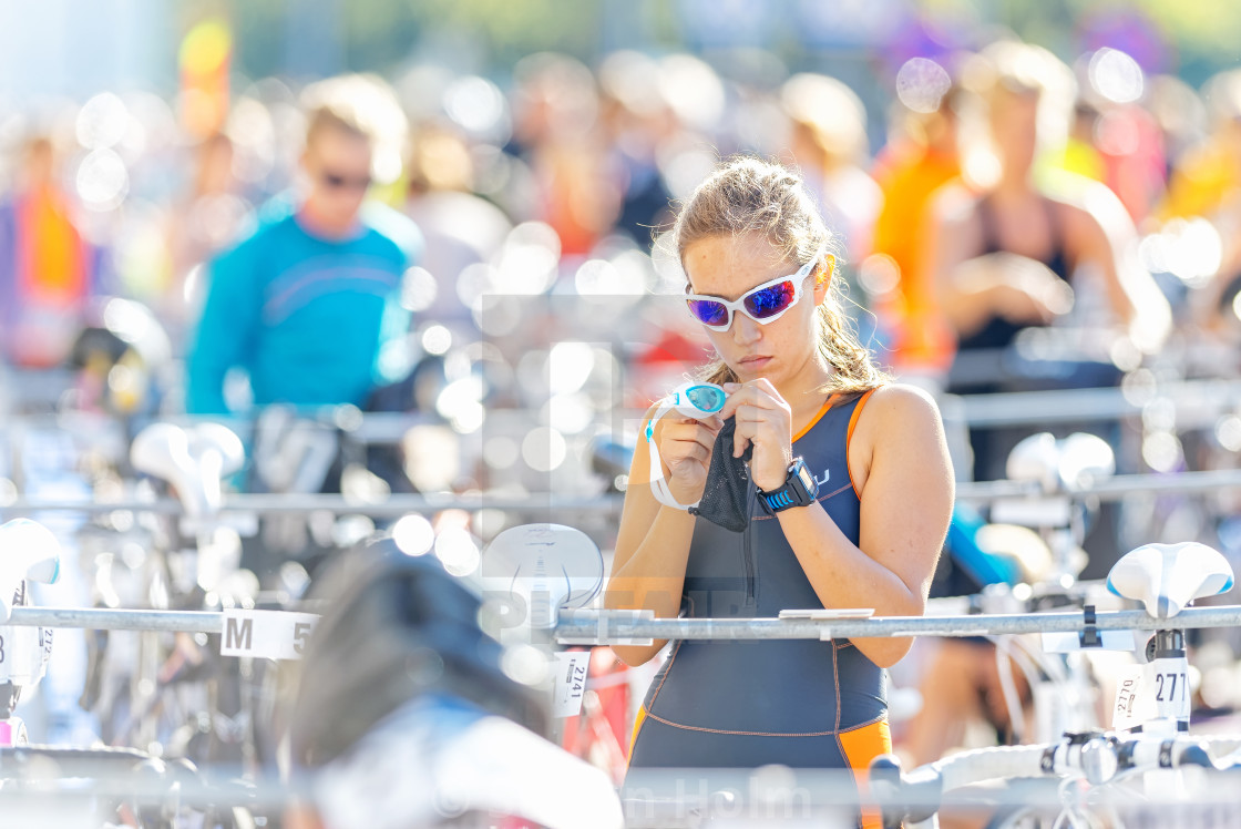 "Female triathlete preparing and fixing with her goggles before t" by Stefan Holm - $6.32 "Female triathlete preparing and fixing with her goggles before t" stock image