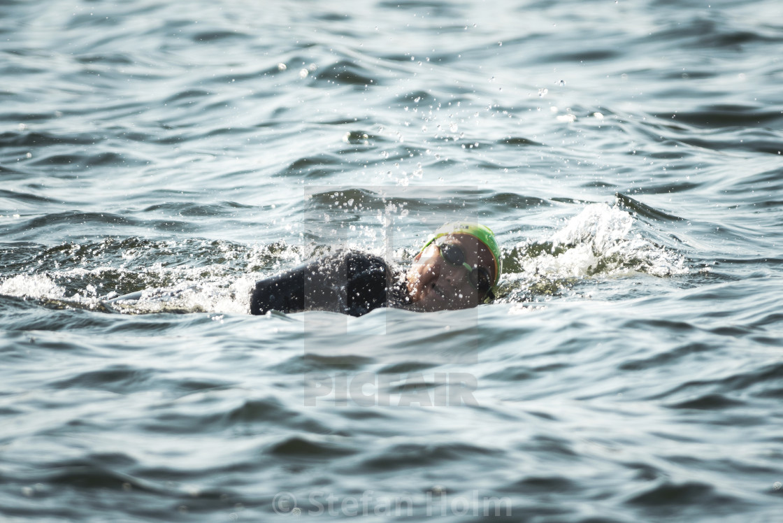 "Triathlon female swimmers warming up and preparing out on the je" by Stefan Holm - $6.35 "Triathlon female swimmers warming up and preparing out on the je" stock image