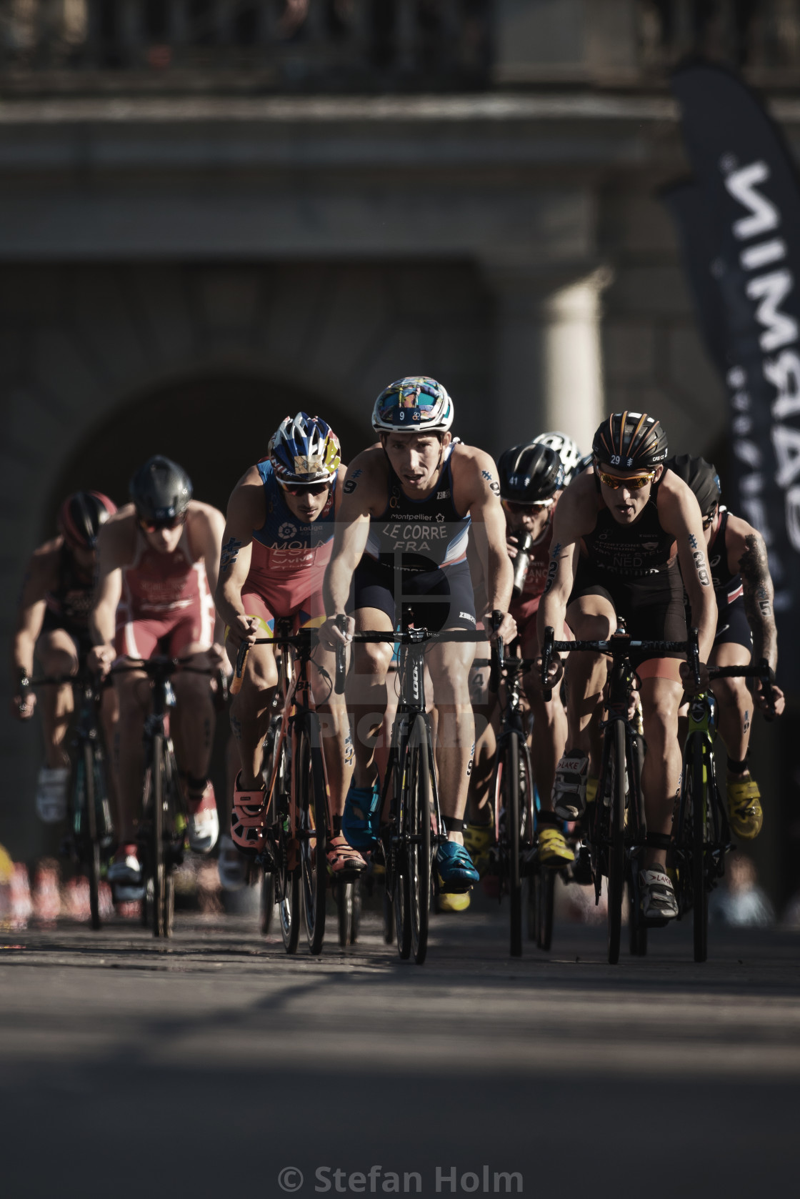 "Leading group of triathletes on bike lead by Pierre Le Corre (FR" stock image
