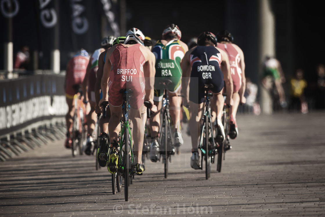 "Backs of a group of triathletes on bikes in the ITU triathlon se" by Stefan Holm - $6.32 "Backs of a group of triathletes on bikes in the ITU triathlon se" stock image