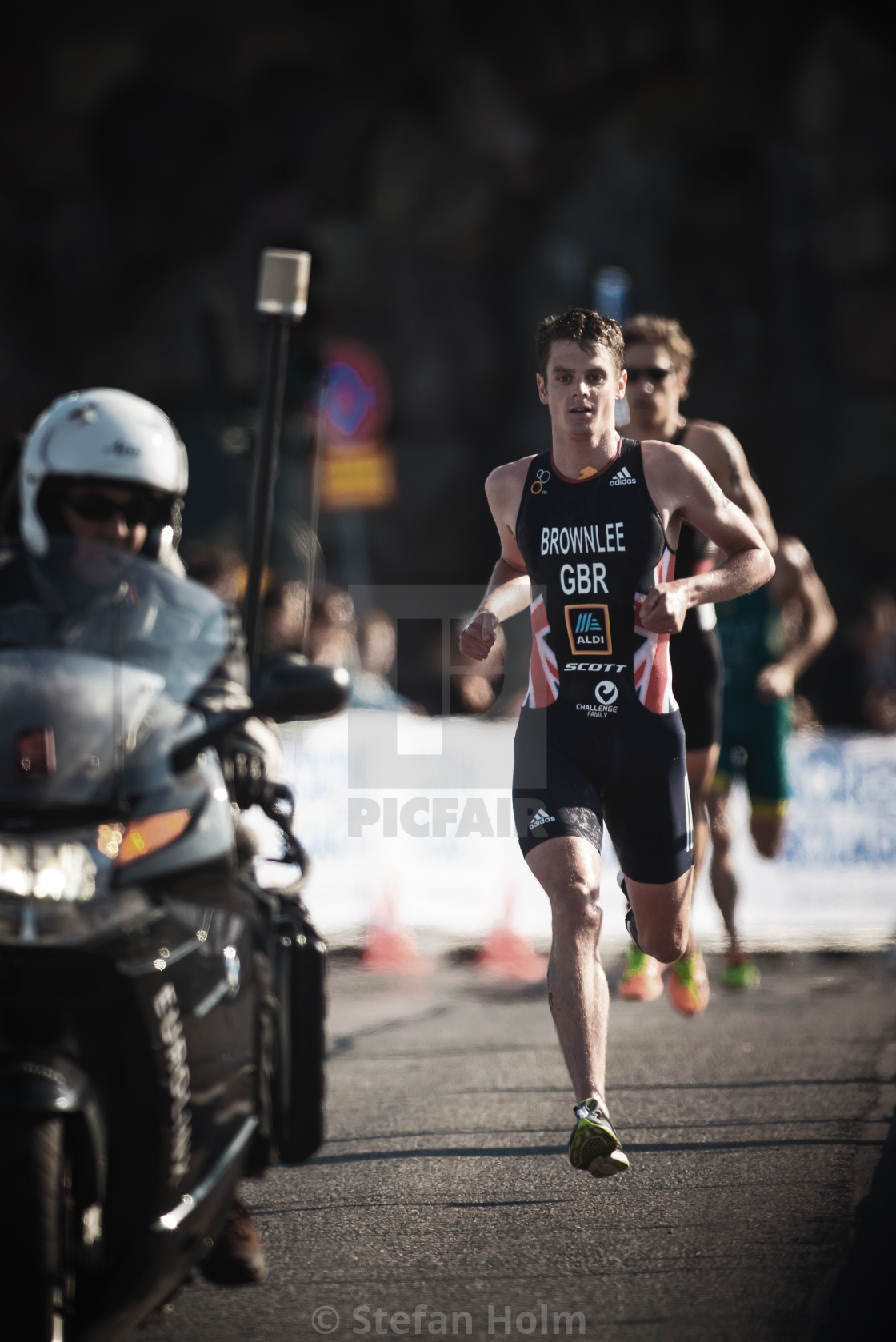 "Jonathan Brownlee (GBR) running trough the streets of the old ci" by Stefan Holm - $6.34 "Jonathan Brownlee (GBR) running trough the streets of the old ci" stock image