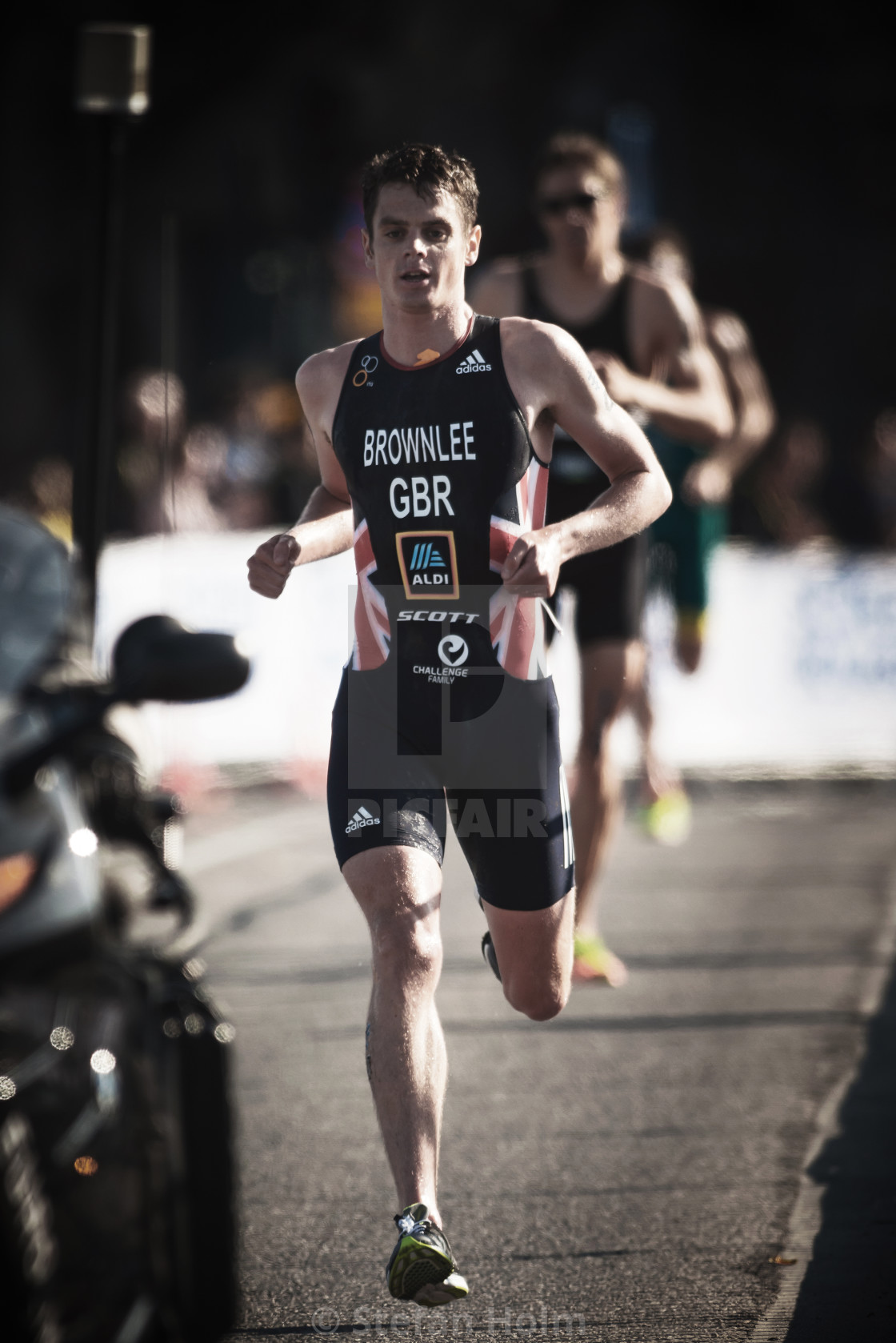"Jonathan Brownlee (GBR) running trough the streets of the old ci" by Stefan Holm - $6.34 "Jonathan Brownlee (GBR) running trough the streets of the old ci" stock image