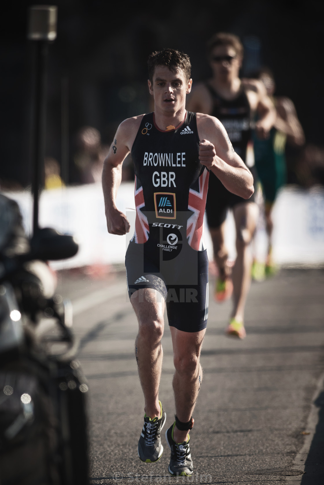 "Jonathan Brownlee (GBR) running trough the streets of the old ci" by Stefan Holm - $6.35 "Jonathan Brownlee (GBR) running trough the streets of the old ci" stock image