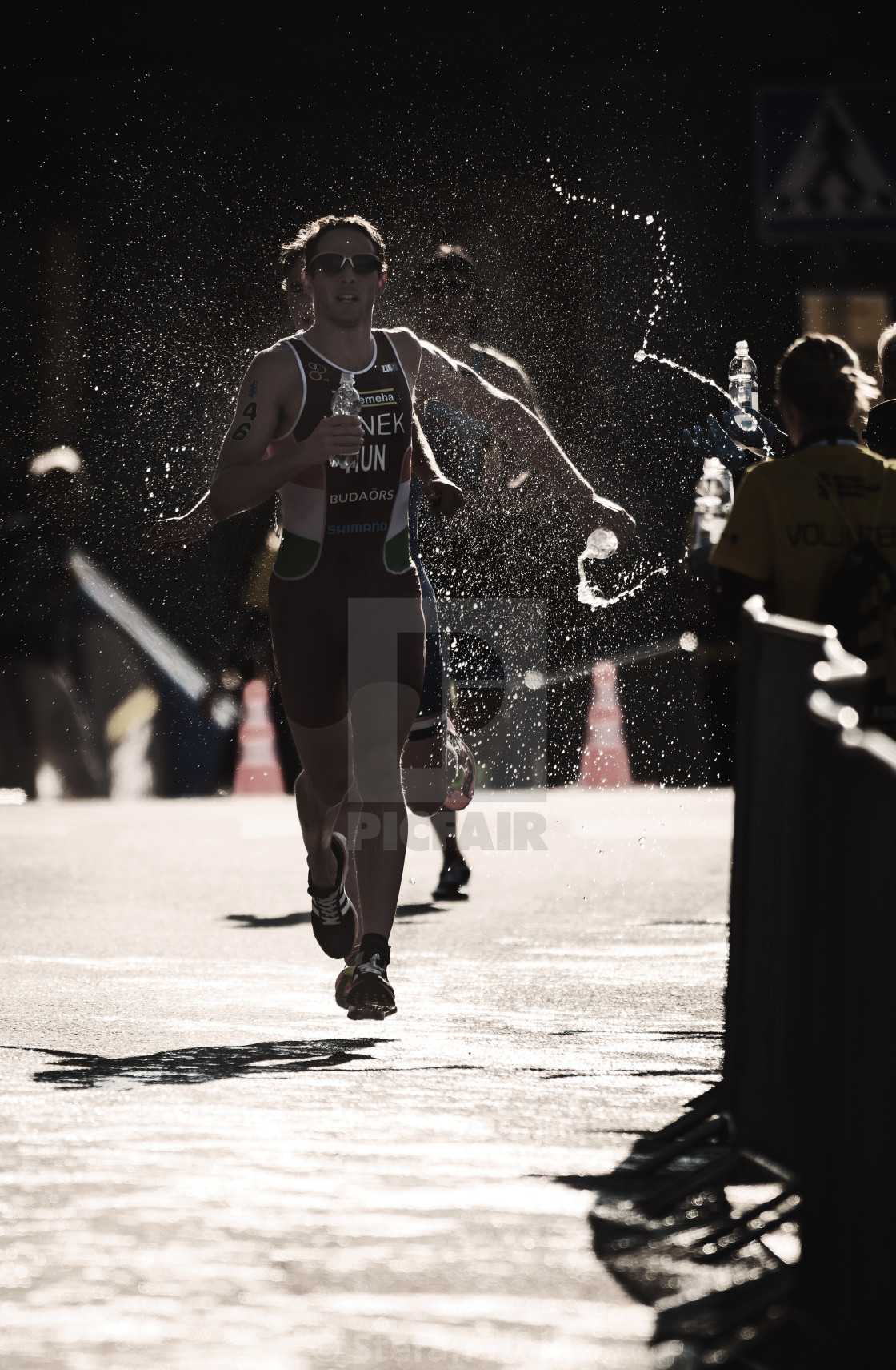"Akos Vanek (HUN) running trough the waterstation at the ITU tria" by Stefan Holm - $6.32 "Akos Vanek (HUN) running trough the waterstation at the ITU tria" stock image