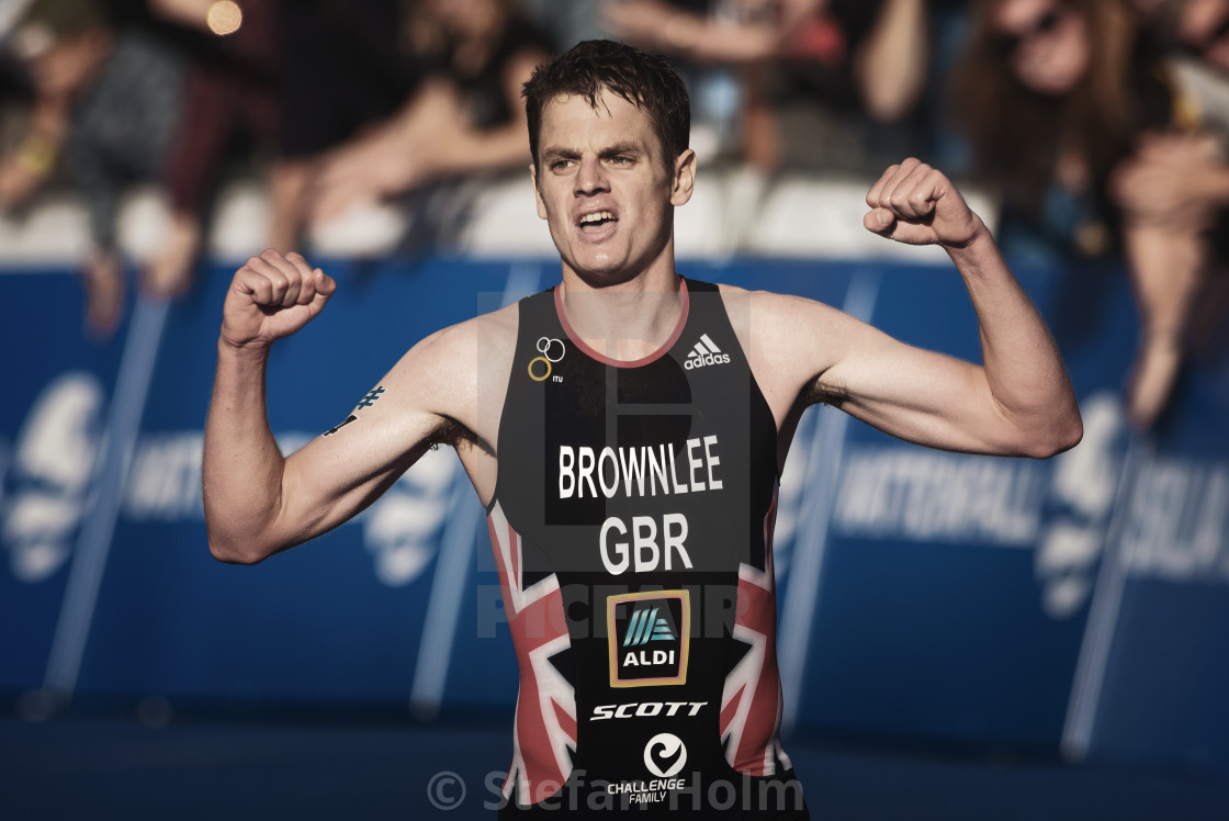 "Winner Jonathan Brownlee (GBR) running to the finishline and cel" by Stefan Holm - $6.30 "Winner Jonathan Brownlee (GBR) running to the finishline and cel" stock image