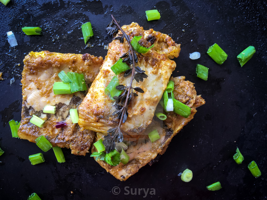 "Pan fried fish with Thyme and spring onions" by Surya - $15.39 "Pan fried fish with Thyme and spring onions" stock image