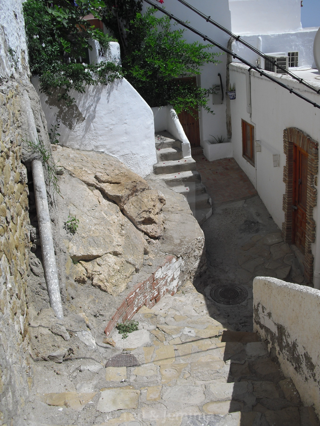 "Steep stairs around rocks on narrow street, Mojacar Pueblo, Almeria, Andalusia, Spain" by Ted & Jemima - $5.06 "Steep stairs around rocks on narrow street, Mojacar Pueblo, Almeria, Andalusia, Spain" stock image