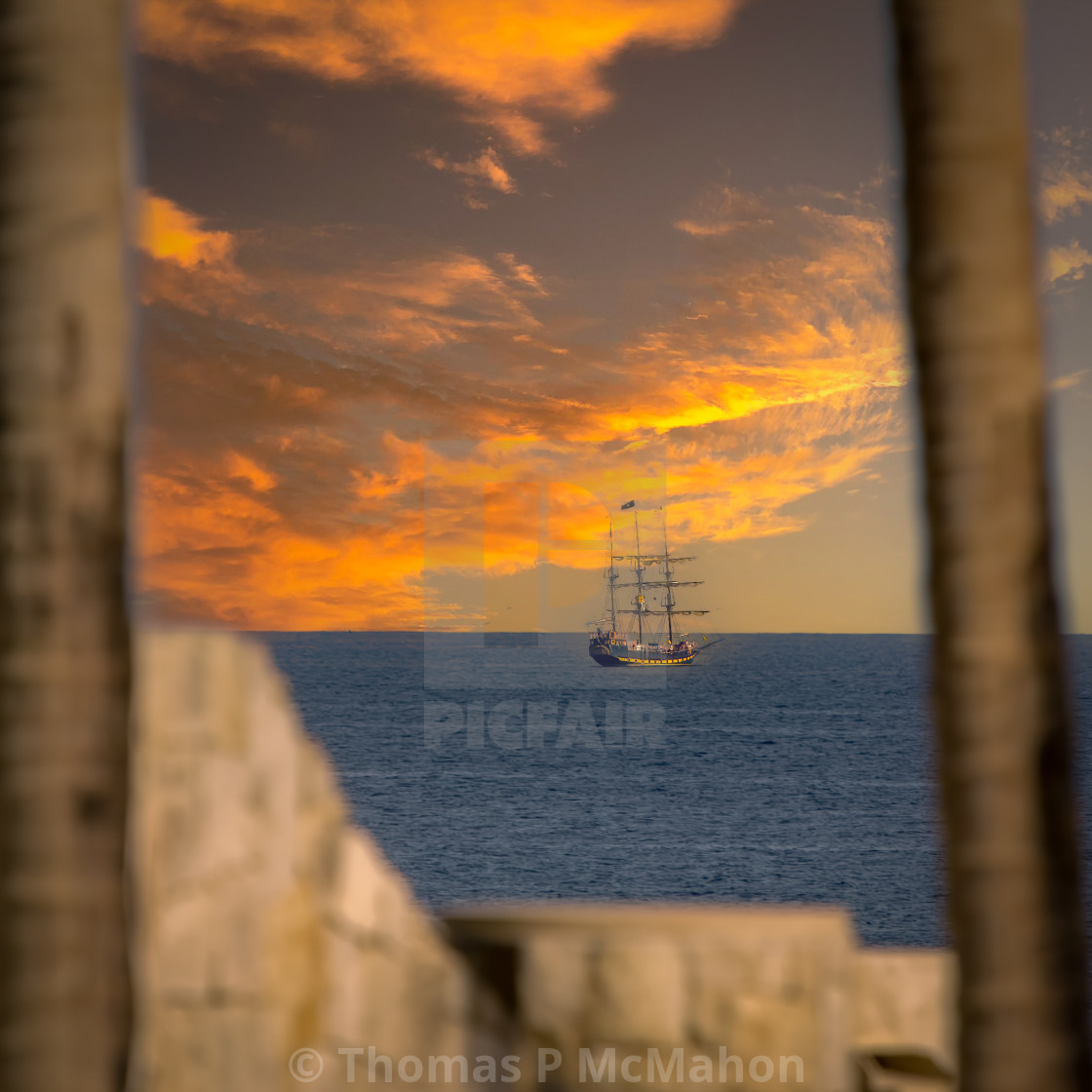 "Tall ship on the ocean at sunset" stock image