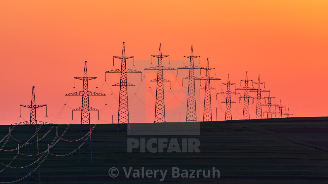 "Power transmission towers in the field" stock image