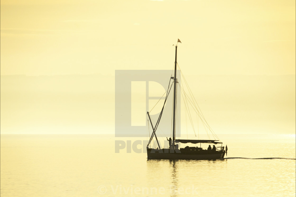 "Gaff rigged vessel at sunset" stock image