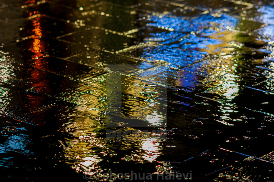 "Bright colored lights on wet pavement" by Yehoshua Halevi - $4.90 "Bright colored lights on wet pavement" stock image