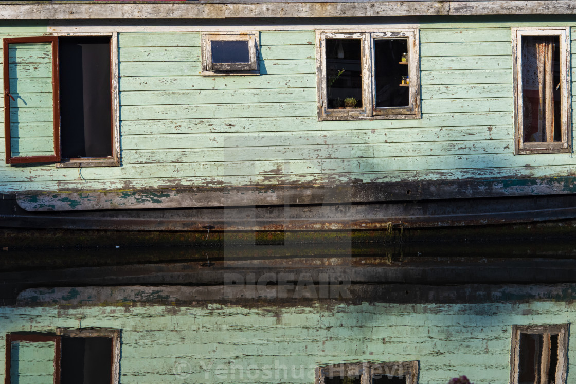 "A houseboat reflected in a still canal in Amsterdam" by Yehoshua Halevi - $6.08 "A houseboat reflected in a still canal in Amsterdam" stock image