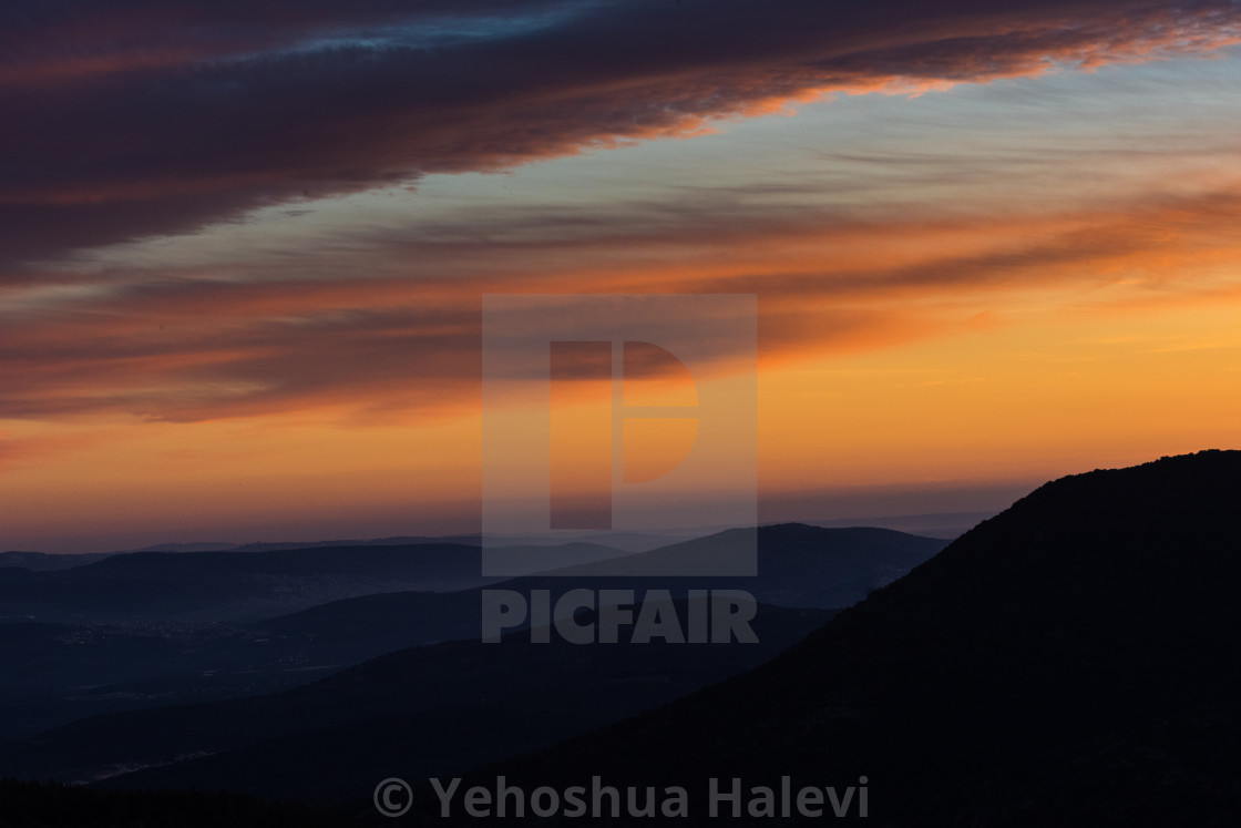 "Waves of color streak across the sky at sunset over the Galilee Mountains in northern Israel." by Yehoshua Halevi - $6.09 "Waves of color streak across the sky at sunset over the Galilee Mountains in northern Israel." stock image