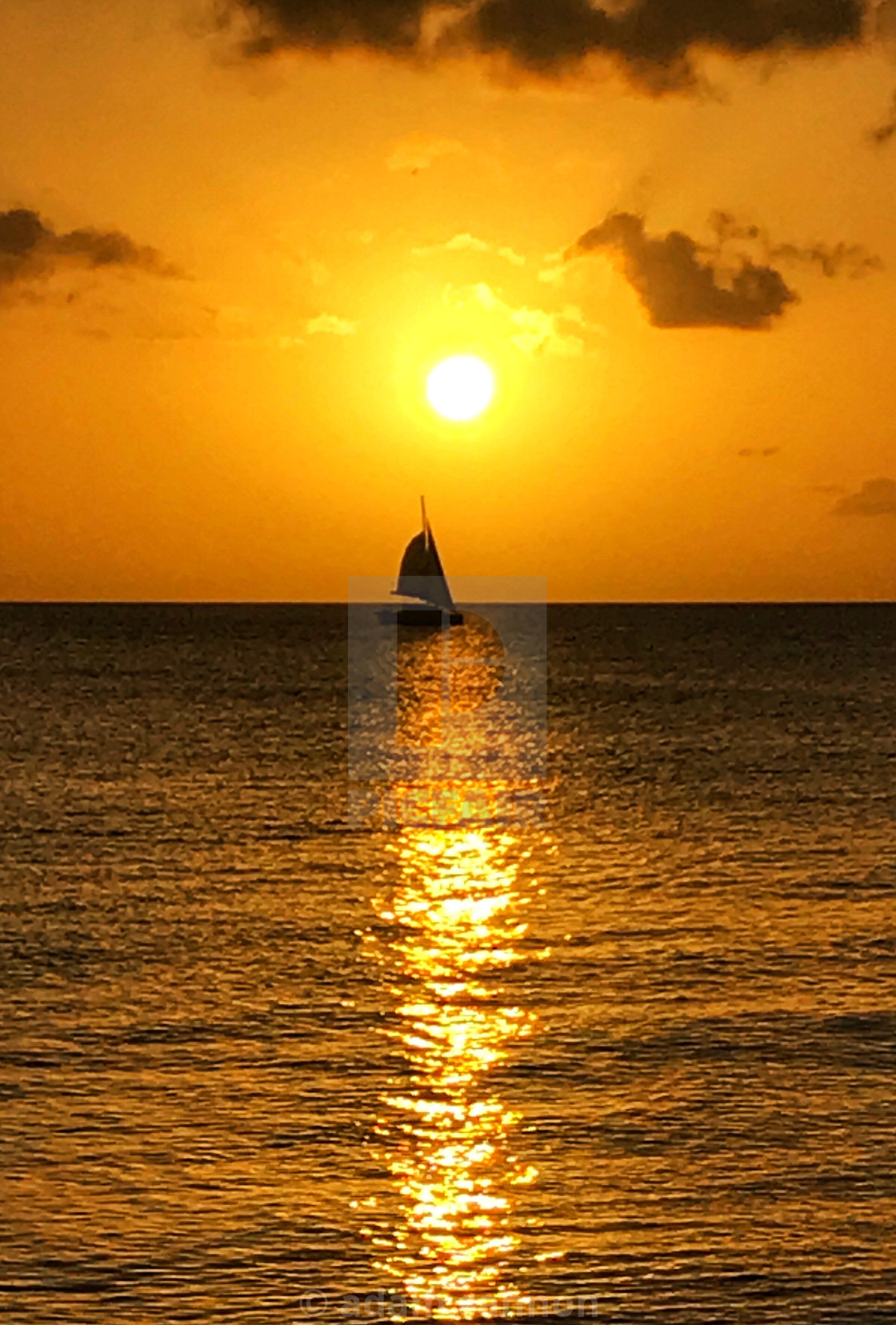 "A barbados sunset and a boat on the water" stock image