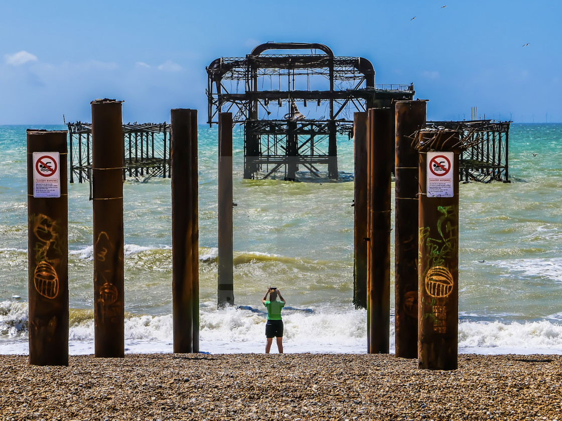 "Taking pictures of the ruined West Pier in Brighton" stock image