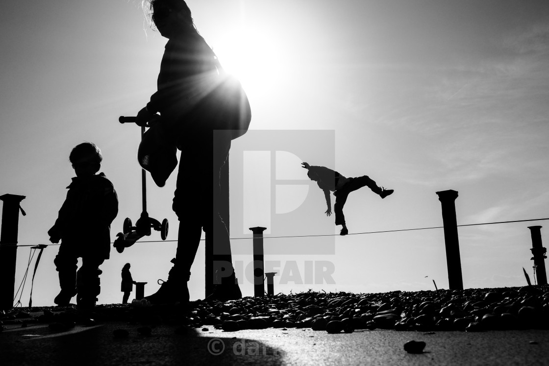"Silhouette of a tightrope walker almost loosing his balance on the beach at Brighton in the UK." by darrylcuz - £6.20 "Silhouette of a tightrope walker almost loosing his balance on the beach at Brighton in the UK." stock image