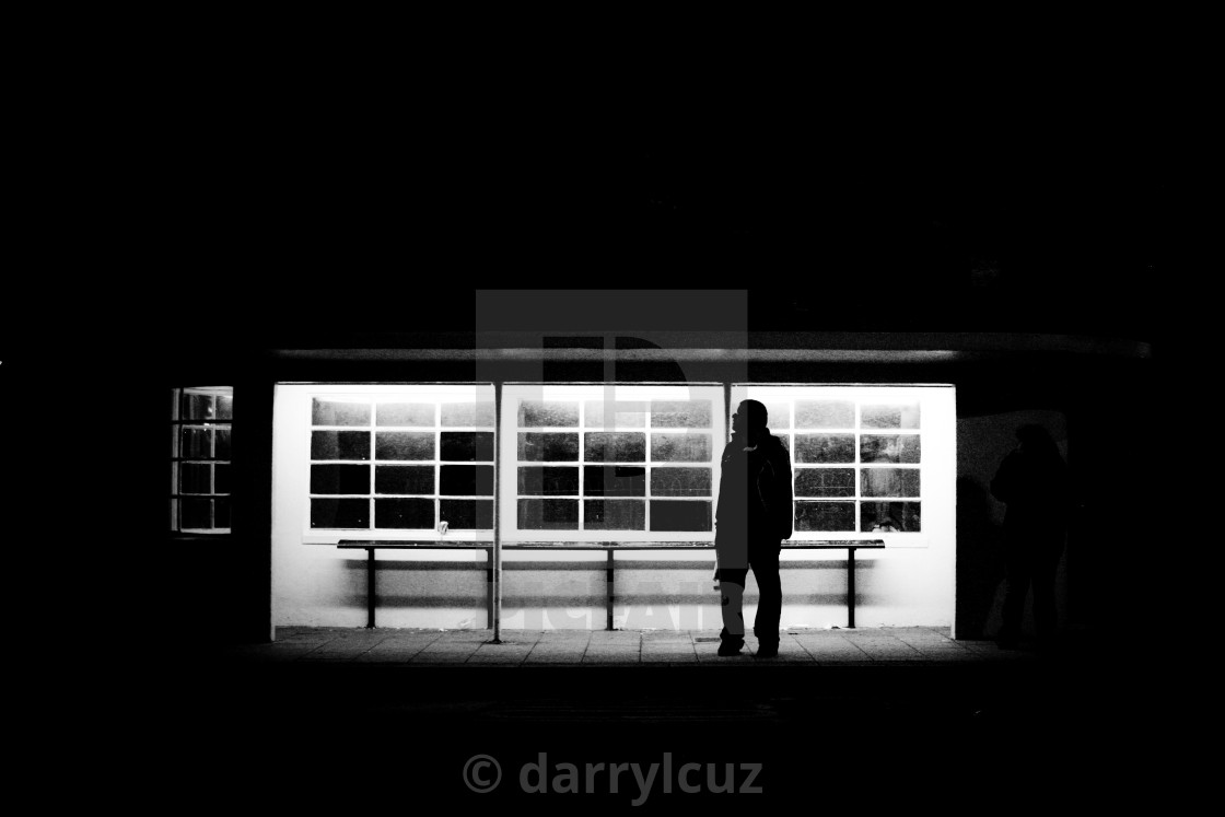 "Night shot of a man in silhouette waiting at a bus stop in Brighton, UK." by darrylcuz - £6.20 "Night shot of a man in silhouette waiting at a bus stop in Brighton, UK." stock image