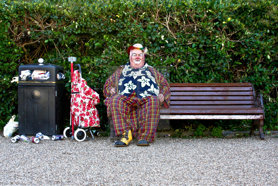 "Clown sitting on a bench with a bin full of rubbish in Hove, Brighton." by darrylcuz - £6.20 "Clown sitting on a bench with a bin full of rubbish in Hove, Brighton." stock image