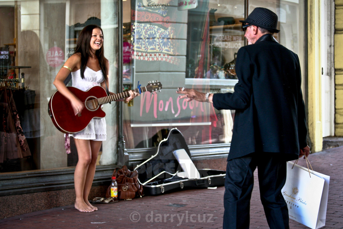 "A girl busking in bare feet with a well dressed man in Brighton, UK." by darrylcuz - £6.20 "A girl busking in bare feet with a well dressed man in Brighton, UK." stock image